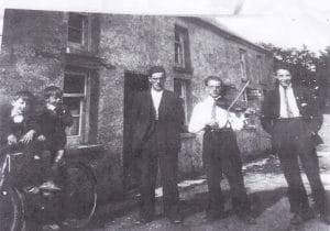 Photo L to R. Two unknown boys, Henry McNamee, Daniel (the fiddler) McBride and Michil James Campbell.